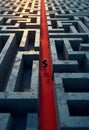 3D maze with cracked stone texture red path dollar sign in center dramatic lighting shadow effect perspective view Royalty Free Stock Photo