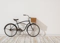 3d model of black retro bicycle with basket in front of the white wall, background