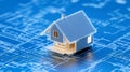 A 3D model of a house blueprint placed on top of a blueprint background symbolizing construction architecture planning design Royalty Free Stock Photo