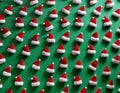 a 3d modeled cenital view, aerial view of a playful pattern design featuring many santa claus\'s hats partially embedded in a
