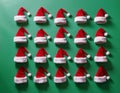 a 3d modeled cenital view, aerial view of a playful pattern design featuring many santa claus\'s hats partially embedded in a