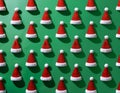 a 3d modeled cenital view, aerial view of a playful pattern design featuring many santa claus\'s hats partially embedded in a