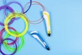 3d pens with colourful plastic filament on blue background