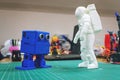 3D printed astronaut, cosmonaut and cute robot on the background of devices and laptop.