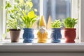 3d-printed color gnomes lined up on a sunny windowsill