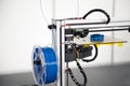 3d printer with blue filament coil close-up. 3d printing process