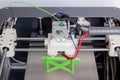 3d printer with bright green filament Royalty Free Stock Photo