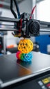 3D printer creating colorful geometric spherical objects in a workshop environment Royalty Free Stock Photo