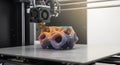 A 3D printer creating a complex, colorful object with intricate, layered details, showcasing the capabilities of additive Royalty Free Stock Photo