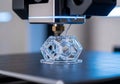 A 3D printer is creating a geometric structure using transparent Royalty Free Stock Photo