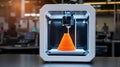 3 D printer creating orange cone object in laboratory Royalty Free Stock Photo
