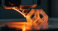 A 3D printer is creating a complex geometric object with precision and detail using a heated nozzle and orange filament Royalty Free Stock Photo
