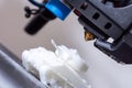 3D printer hotend. Close-up of 3D printing with FDM filament. Small plastic tank. Royalty Free Stock Photo