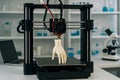 3D printer in a laboratory setting is printing a prosthetic human hand. Royalty Free Stock Photo