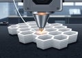 A 3D printer nozzle actively fabricating a hexagonal patterned object Royalty Free Stock Photo