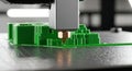3D Printer Nozzle Extruding Green Filament on Layered Object Royalty Free Stock Photo