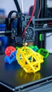 3D printer nozzle extruding yellow plastic filament creating a complex geometric shape on a build plate Royalty Free Stock Photo
