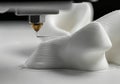 3D printer nozzle extruding white filament, creating intricate shapes on a flat surface, showcasing advanced technology and Royalty Free Stock Photo