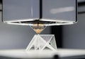 A 3D printer is in operation, creating a geometric structure Royalty Free Stock Photo