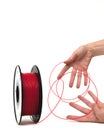3D Printer Plastic Filament. Spool of red thermoplastic wire in hands. Royalty Free Stock Photo