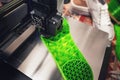 3D-printer produces a shoe sole with distinct inner structure from green plastic filament.