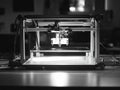 A 3D printer sitting on a table, ready for use Royalty Free Stock Photo