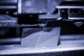 3D printer works and creates an object from the hot molten plastic