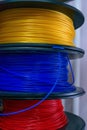 3D printing material, ABS filament, PLA & x28;Polylactic Acid& x29;,  PVA Filament.  Colored polymer in coils on the shelves Royalty Free Stock Photo