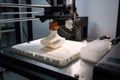 3d printing robot depositing layer of material onto 3d printing bed