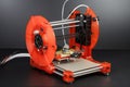 3d printing robot, with extruder head and nozzle printing on roll of filament