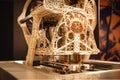 3d printing robot in mid-print, extruding filament in intricate pattern