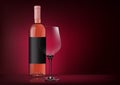 Vector image of a bottle of pink wine with label and a glass goblet in photorealistic style on a red dark background. 3d