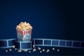 3D realistic film strip with popcorn on blue background. Cinema festival template with space text. Movie design for flyer, banner Royalty Free Stock Photo