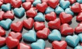 3D red and blue heart-shaped objects arranged in grid-like pattern on dark background. Royalty Free Stock Photo