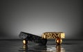 3d render, abstract modern minimal background with black and gold cobblestones, golden balls and reflection in the water. Royalty Free Stock Photo