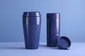 3d render of blue thermos bottle with lid on blue background Royalty Free Stock Photo