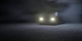 3d render of car with headlights on in a spooky, foggy paved environment