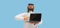 3d render, cartoon character arab man with beard wears traditional white clothes, holds laptop and points with finger at it.