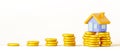 3d render cartoon house icon on stacks of gold coins. Concept of money savings, mortgage or loan for purchase home