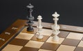 3d render chessboard with king and queen checkmate on black background