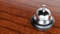 chrome Reception bell isolated on wooden background, hotel bell Royalty Free Stock Photo