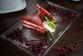 Beautifully served red-white cake on a glass plate with a berry Royalty Free Stock Photo