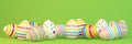 3d render - 13 colorfu Easter eggs on green background