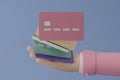 3D render credit cards in hand with cartoon style isolate on blue background. Online payment concept on blue background. Income,