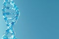 A closeup of a shimmering blue DNA helix against a soft blurred blue background Royalty Free Stock Photo