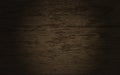 3D render of dark brown wooden plank texture with spot light on center