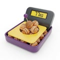 Digital Scale Displaying 77 KG with Pile of Chocolate Balls on White Background weight scale Royalty Free Stock Photo