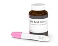 3d render of folic acid pills and pregnancy test