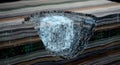 3D render of a glowing digital cube embedded in layered rock strata with binary code Royalty Free Stock Photo