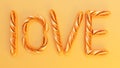 golden french baguettes forme a love word on yellow background Royalty Free Stock Photo